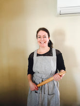 Load image into Gallery viewer, A baker in a blue striped Hovden Wear apron, holding a rolling pin.