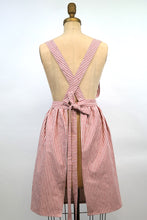 Load image into Gallery viewer, Red and white striped Hovden Wear apron, back view. Straps cross in the back.